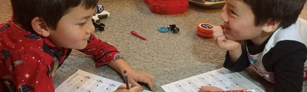 2 Children Learning to Read Sheet Music
